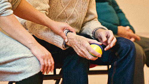 Older people holding hands 